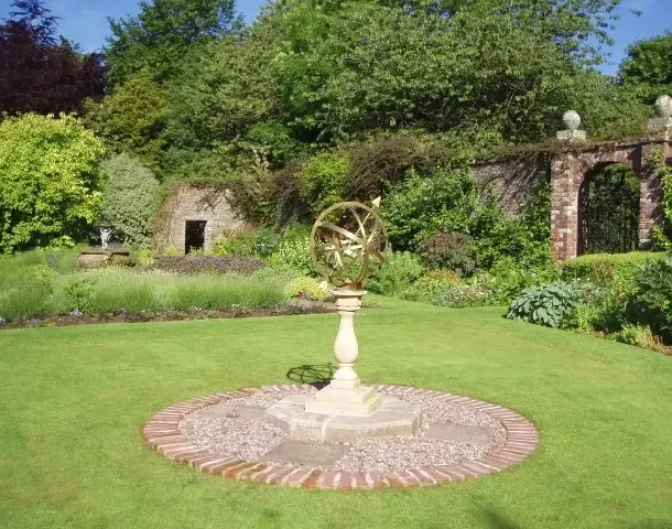 Walled Garden An open space in the Walled Garden with an armillary sundial in the foreground and a gateway and a picturesque ruin in the background
