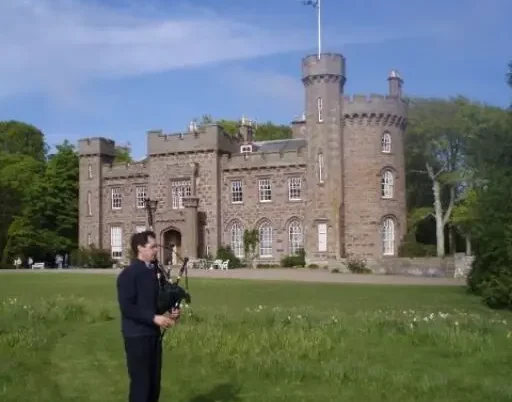 OLYMPUS DIGITAL CAMERA Dunninald Castle, with bagpipes and the Saltire flying high