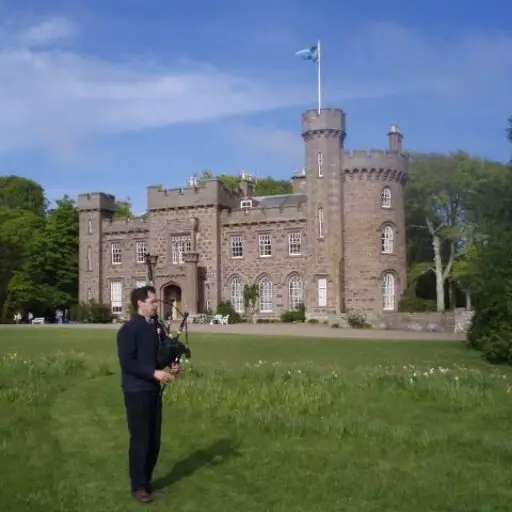 Dunninald Castle, with bagpipes and the Saltire flying high